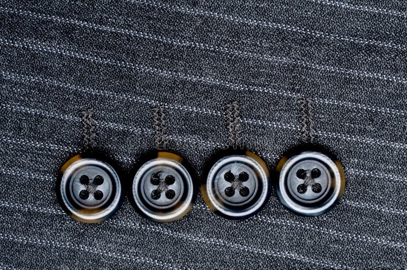 Close up of four buttons on a pin-striped suit jacket. Button clasp stock images, royalty-free photos and pictures