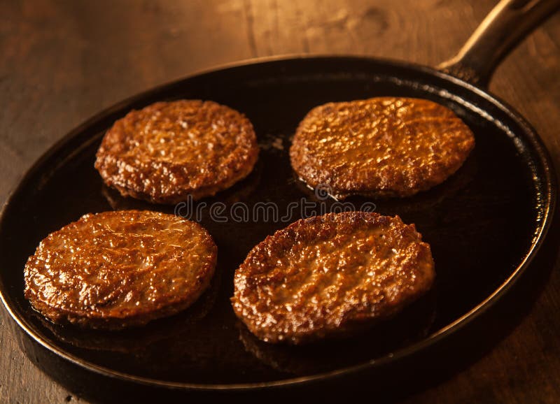 Four cooked spicy beef patties or frikadeller