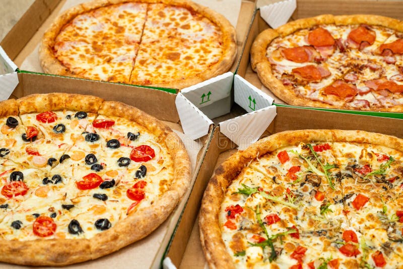 Four Different Cut Pizzas are in Square Boxes. Meat and Vegetarian