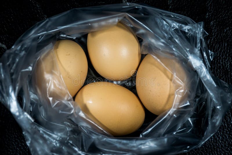 Fresh eggs in plastic bag stock photo. Image of shadows 101042360