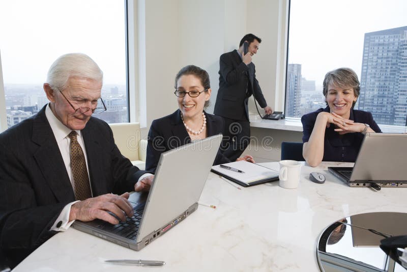 Four executives meeting with laptops in a conferen royalty free stock images Four executives meeting with laptops in a conferen royalty free stock images
