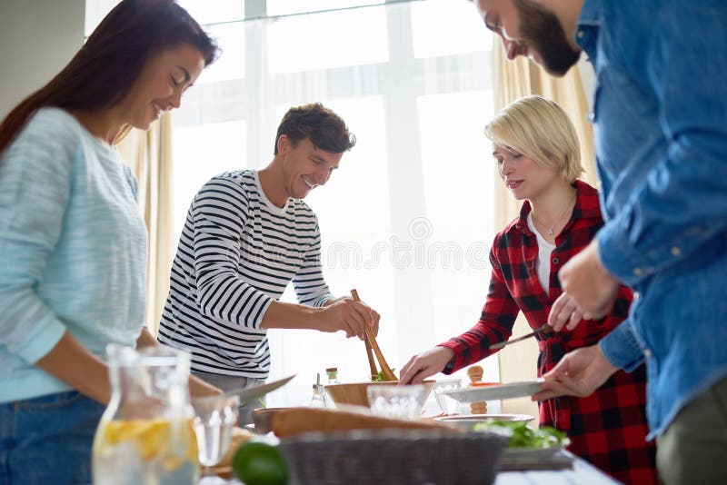 Four Friends Preparing Dinner Together Stock Photo - Image of making