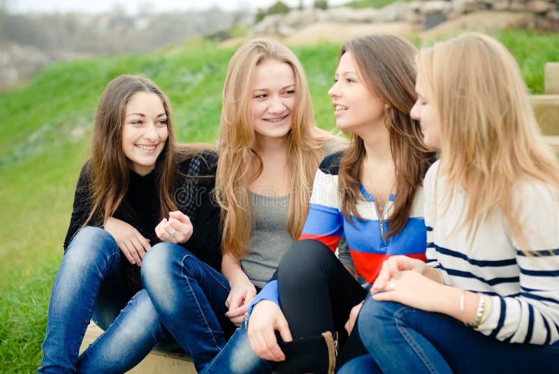 Four Happy Teen Girls Friends Having Fun Outdoo