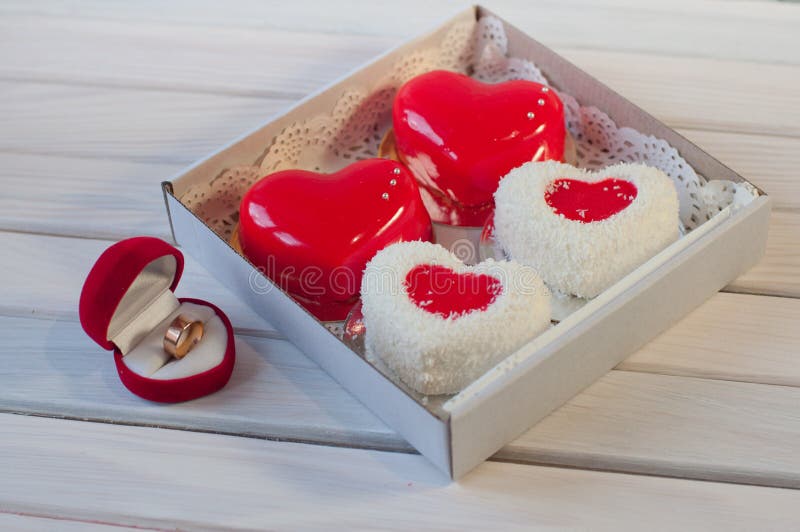 Four Heart Shaped Cakes in Box and Wedding Ring on Table Stock Photo Image of sweets, present