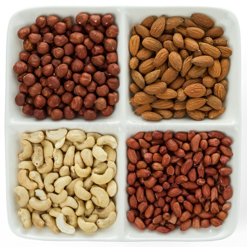 Four kinds of nuts in four compartments of combination plate royalty free stock photos