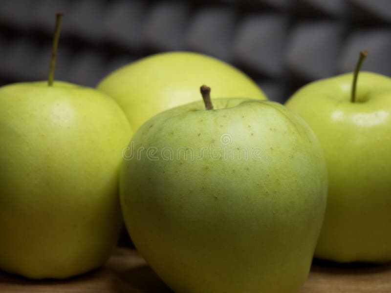 Four large apples, close-up. Fruit on a wooden surface royalty free stock photos