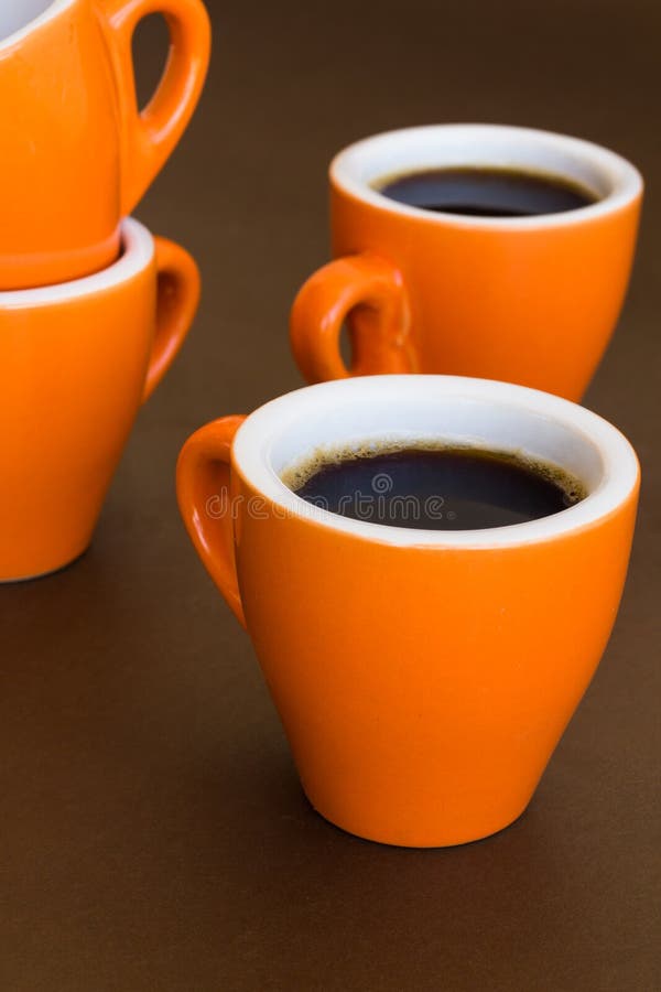 Four Modern Cups of Coffee on a Brown Surface Stock Image Image of