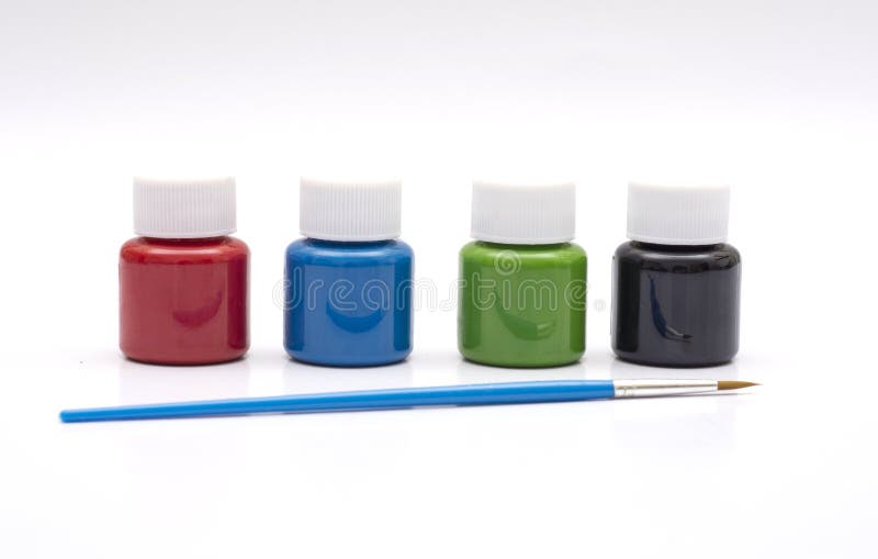 Four Paint Bottles in Prime Colors with Painting Brush Stock Photo