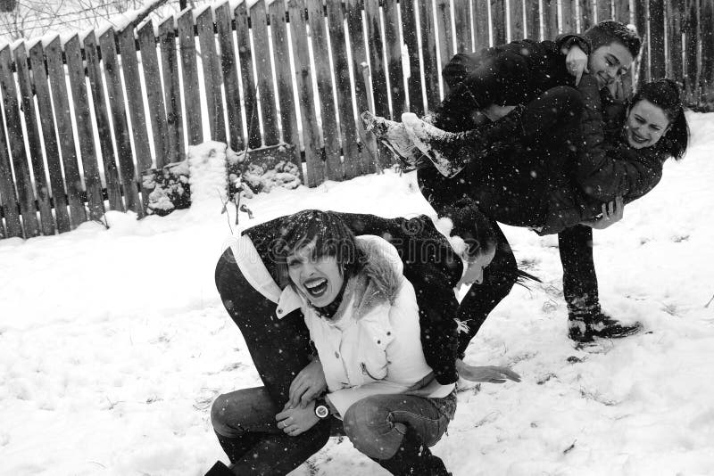 Four people playing in snow