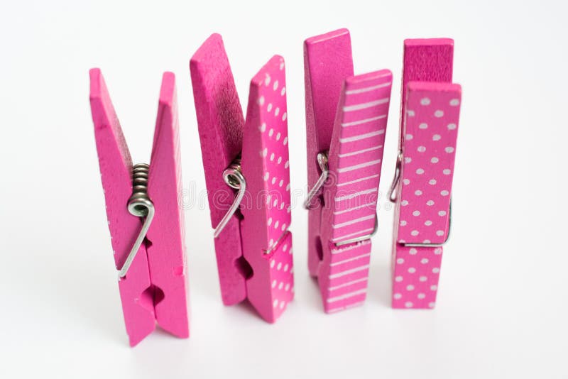 Four Pink Clothes Pins with Fun Patterns Standing Up Front View Stock