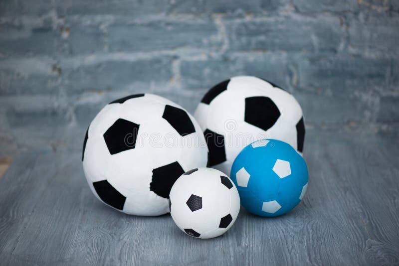 Four Soccer Balls on a Gray Brick Wall Background Stock Photo Image