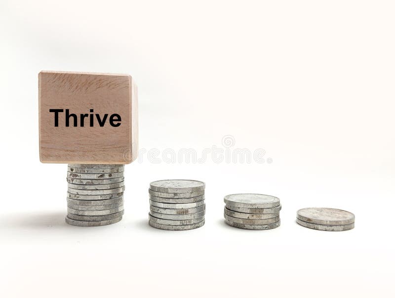 Four stacks of silver coins in increasing height with a wooden block featuring the word Thrive on the tallest stack. Business growth concept. coins concept. Word thrive stock images, royalty-free photos and pictures