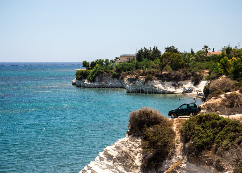 A four wheel drive car dangerously parked next to steep cliff at Governor`s beach, Cyprus