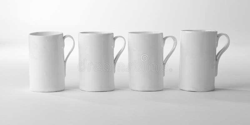 Four White Porcelain Mugs