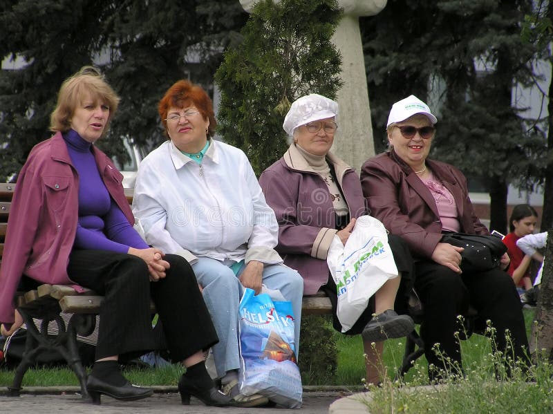 Four women sit on a bench