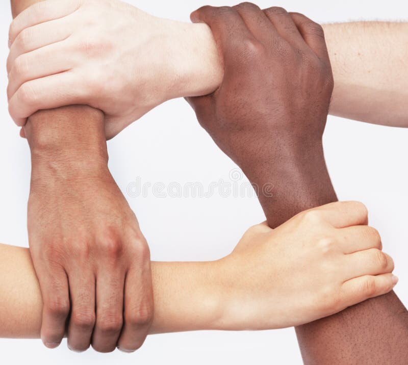 Four young people holding each others wrists in a circle, close-up, studio shot royalty free stock photos Four young people holding each others wrists in a circle, close-up, studio shot royalty free stock photos