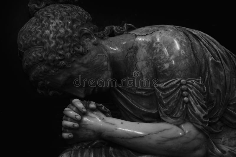 Fragment of an ancient statue of sad and desperate woman on tomb as a symbol of death, pain, sadness and sorrow