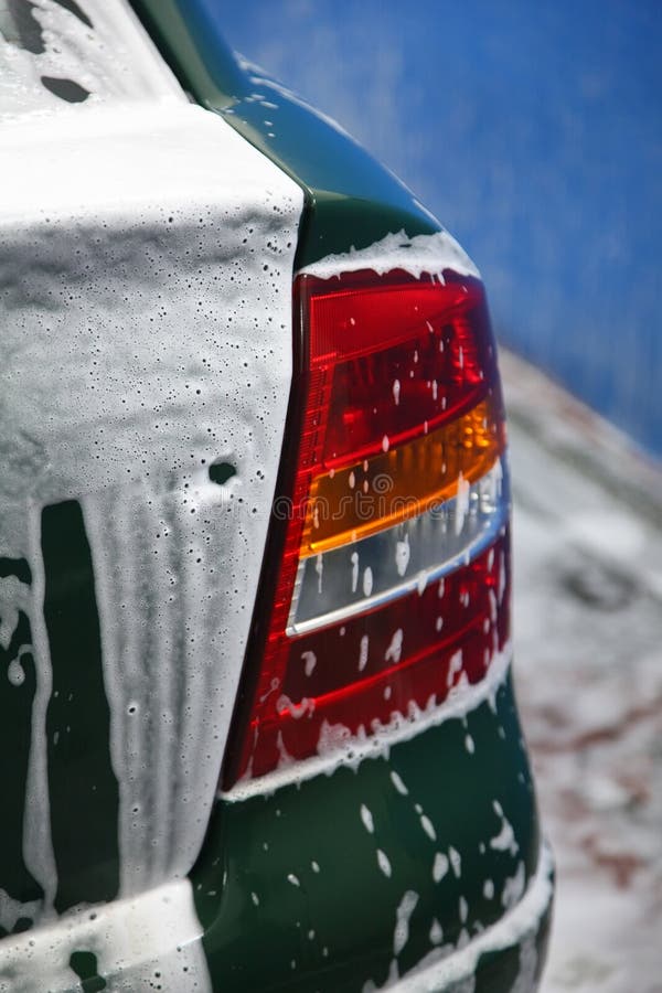 Fragment of automobile in soapsuds on washing stock photo