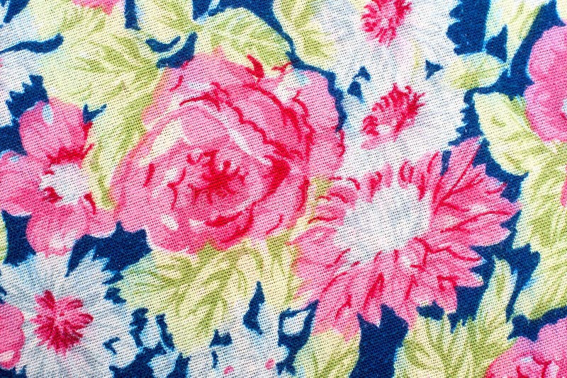 Fragment of colorful retro tapestry textile pattern with handmade floral ornament as background.