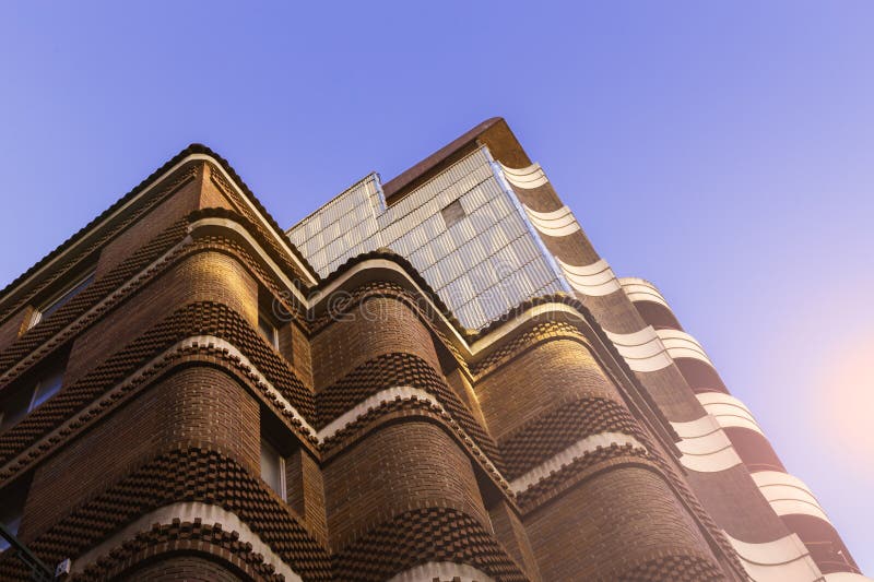 Fragment of the facade of a modern residential building made of bricks - abstract background royalty free stock images