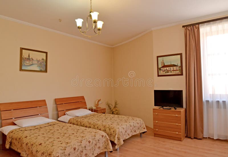 A fragment of an interior of the double hotel room with pictures on walls. Modern classics stock photo