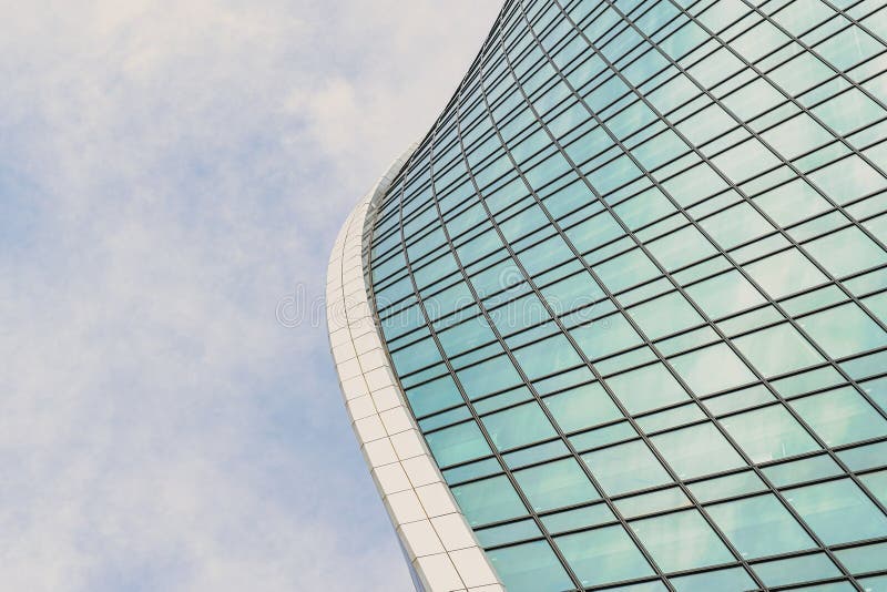 Fragment of a modern office building. Abstract geometric background. Part of a skyscraper with glass windows. stock photo