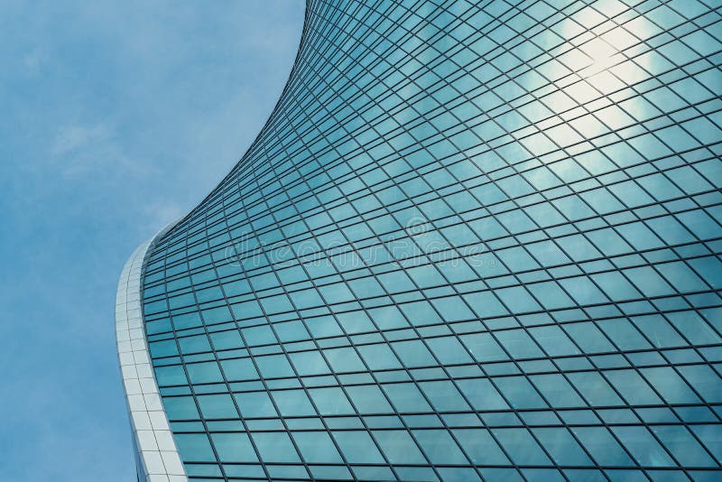Fragment of a modern office building. Abstract geometric background. Part of a skyscraper with glass windows. royalty free stock images