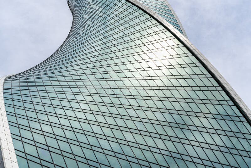Fragment of a modern office building. Abstract geometric background. Part of a skyscraper with glass windows. royalty free stock image