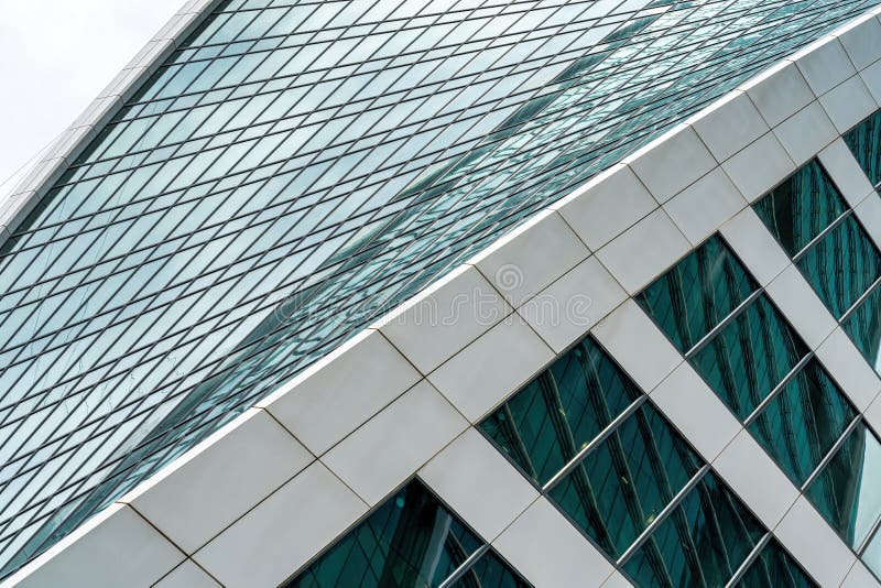 Fragment of a modern office building. Abstract geometric background. Part of a skyscraper with glass windows. stock image