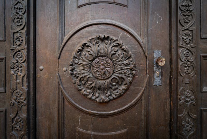 Fragment of an old door decorated with wood carvings stock photos Fragment of an old door decorated with wood carvings stock photos