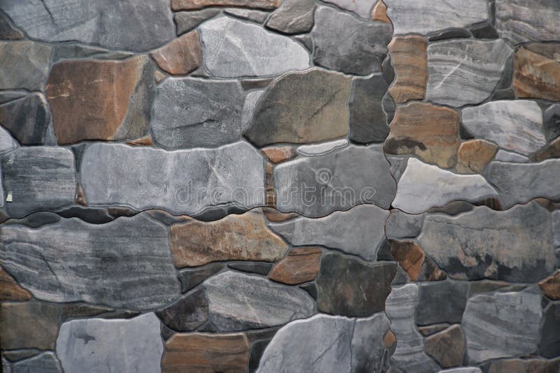 Fragment of stone wall executed from stones of various form and the size. Background image stock images