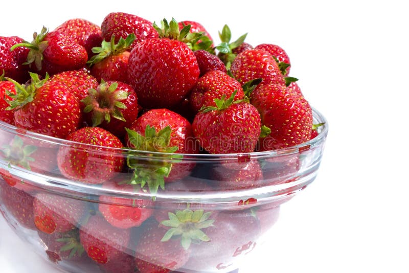 Ripe red strawberries in glass cup isolated on white background. Ripe red strawberries in glass cup isolated on white background.