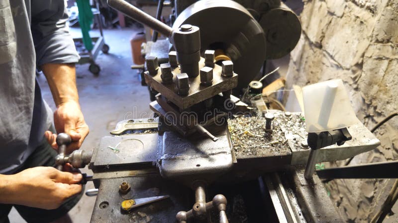 Fraiseuse haute ou étroite dans l'action. Turner méconnaissable travaillant avec le vieil établi dans son garage ou atelier