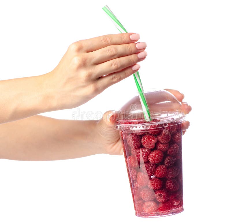 Framboesas em um vidro da limonada à disposição foto de stock