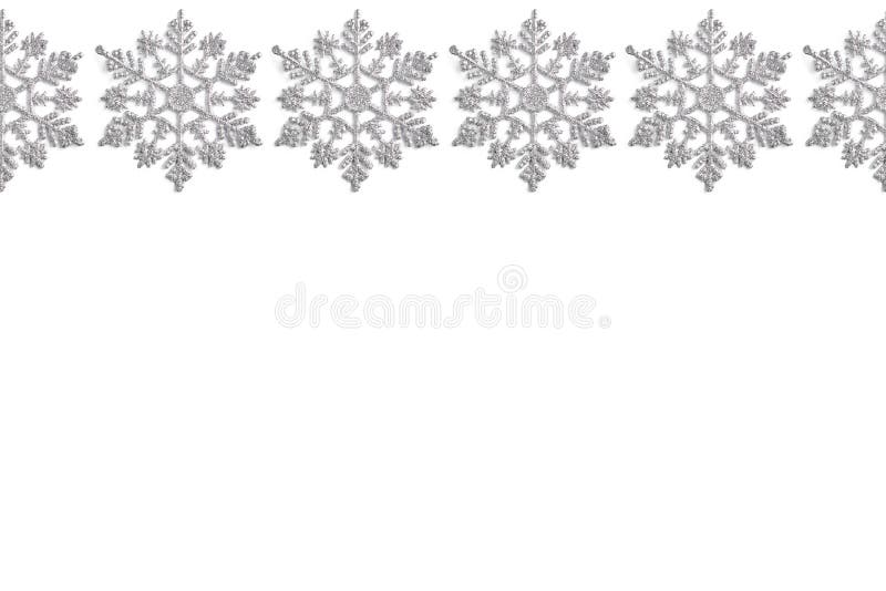 Frame of Christmas decor in the form of silver snowflakes on a white background. new year layout, top view, flat lay royalty free stock photo Frame of Christmas decor in the form of silver snowflakes on a white background. new year layout, top view, flat lay royalty free stock photo