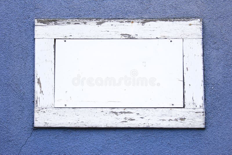 White wood frame with white space as a text field in a blue wall. White wood frame with white space as a text field in a blue wall