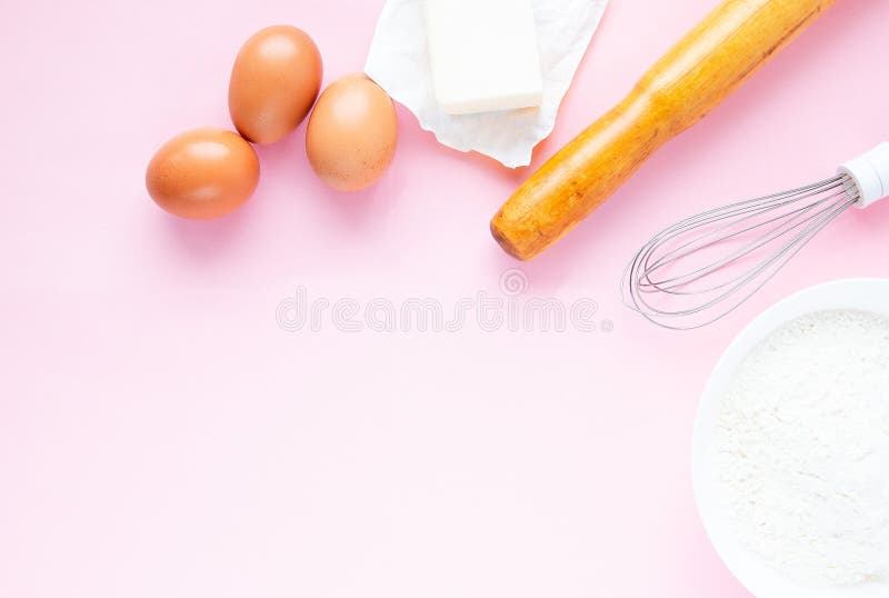 Baking Background on a Pastel Pink Background. Ingredients and Tools