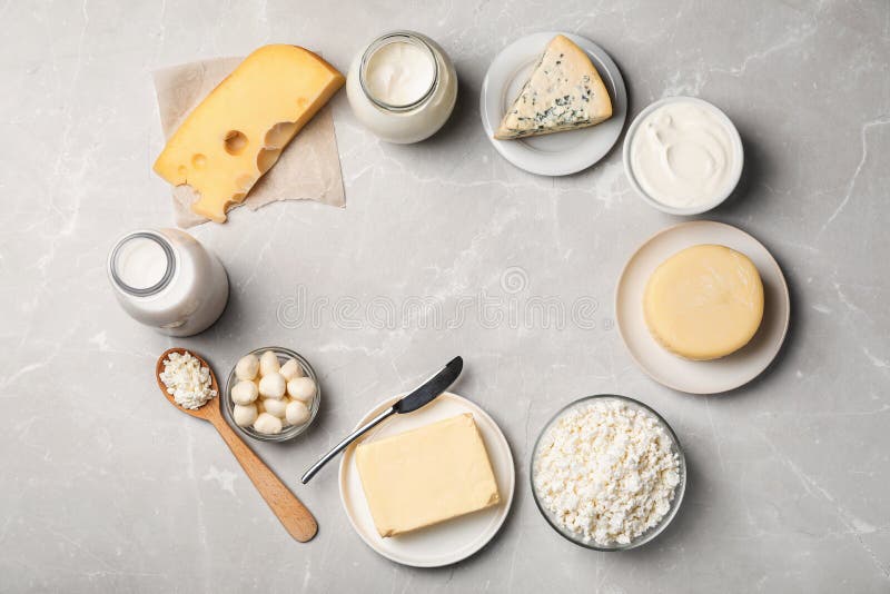 Frame of fresh dairy products on gray background stock images