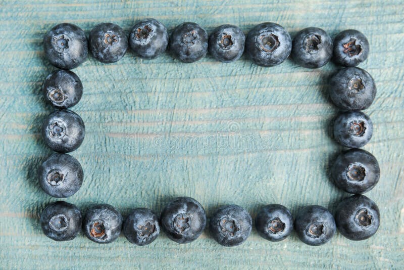 Frame of fresh ripe blueberries on table, flat lay. Space for text royalty free stock image