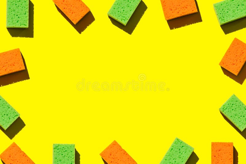 Frame for inscriptions from multi-colored sponges for washing dishes on a yellow background. Multi colored foam sponges stock images, royalty-free photos and pictures