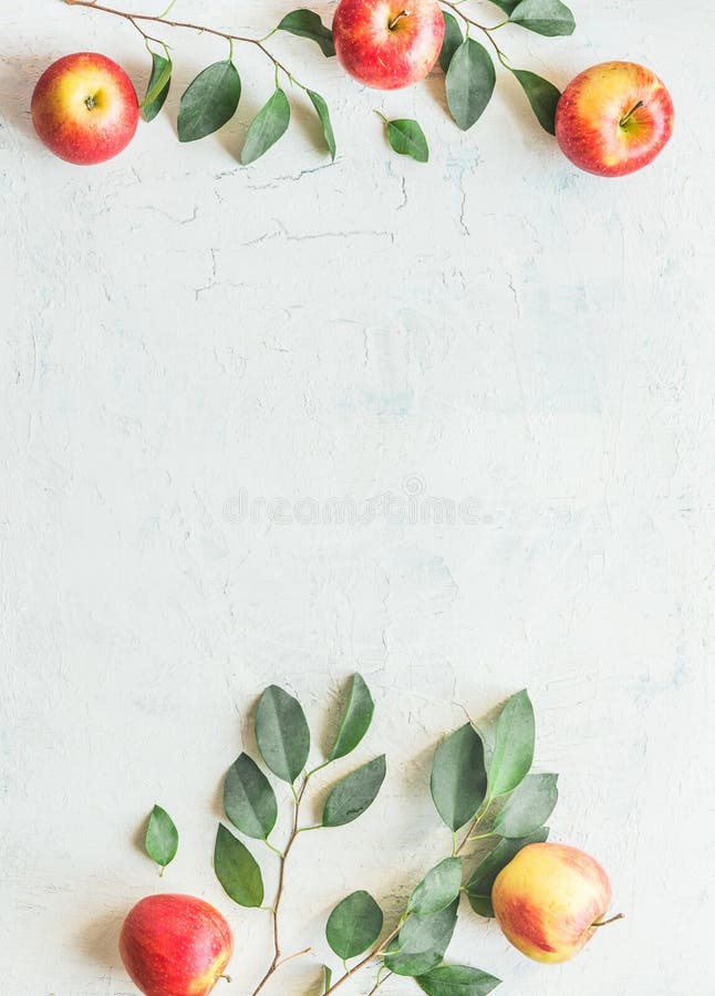 Frame made with apples with green leaves on white background. Top view royalty free stock photos