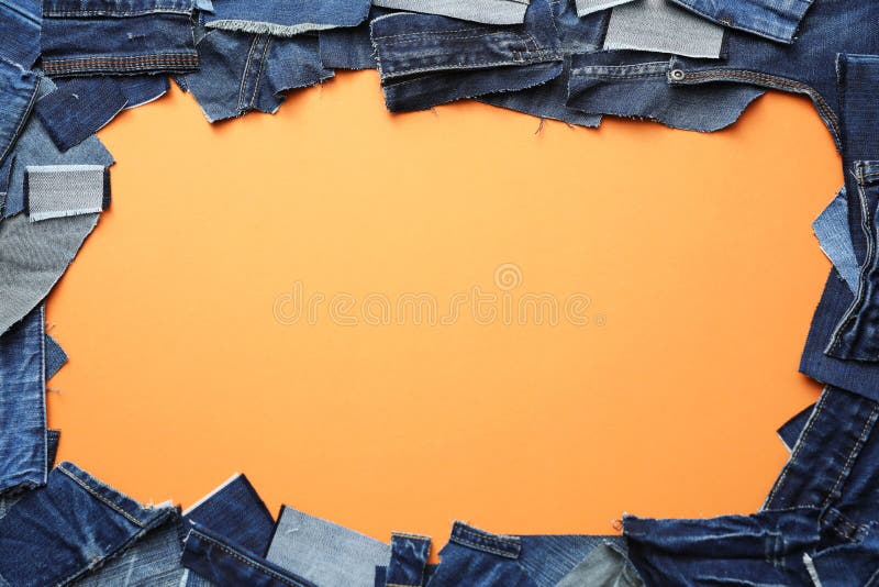 Frame Made of Cut Jeans on Orange Background. Space for Text Stock