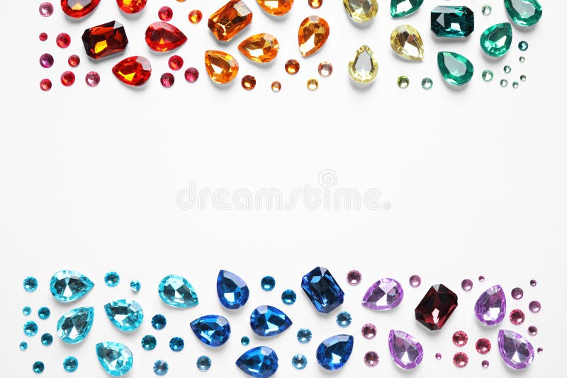 Frame made of different beautiful gemstones on white background. Space for text