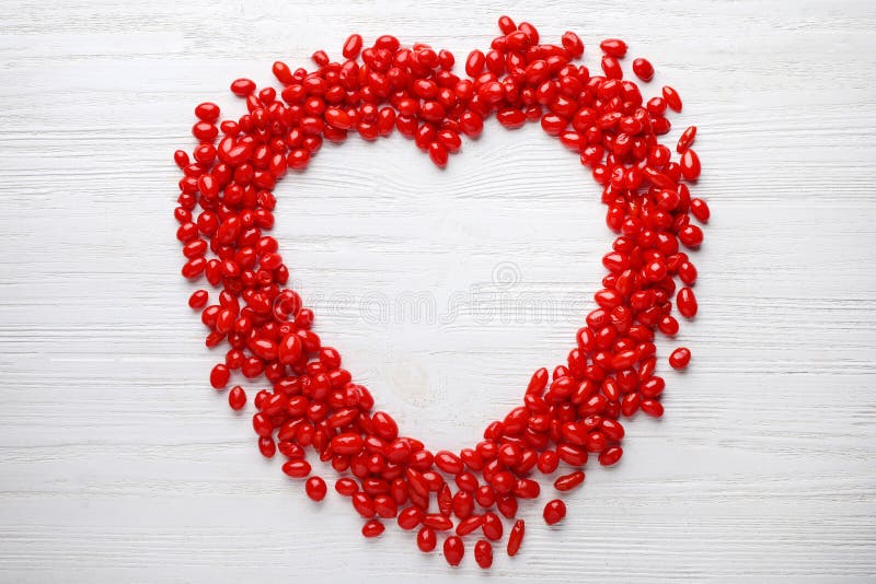 Frame made of fresh ripe goji berries on white wooden table. Space for text royalty free stock images