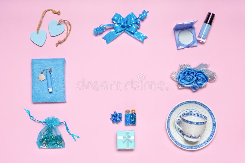 Frame made of stylish feminine accessories, flowers, cosmetics, gifts and decorative items in blue pastel colors on pink stock photo Frame made of stylish feminine accessories, flowers, cosmetics, gifts and decorative items in blue pastel colors on pink stock photo