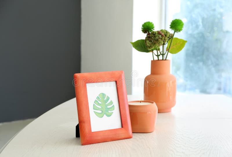 Frame with picture of green leaf and burning candle on white table royalty free stock photos Frame with picture of green leaf and burning candle on white table royalty free stock photos