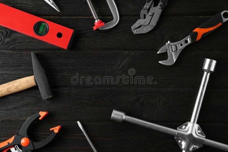 Frame of repair tools on dark background, flat lay. Space for text