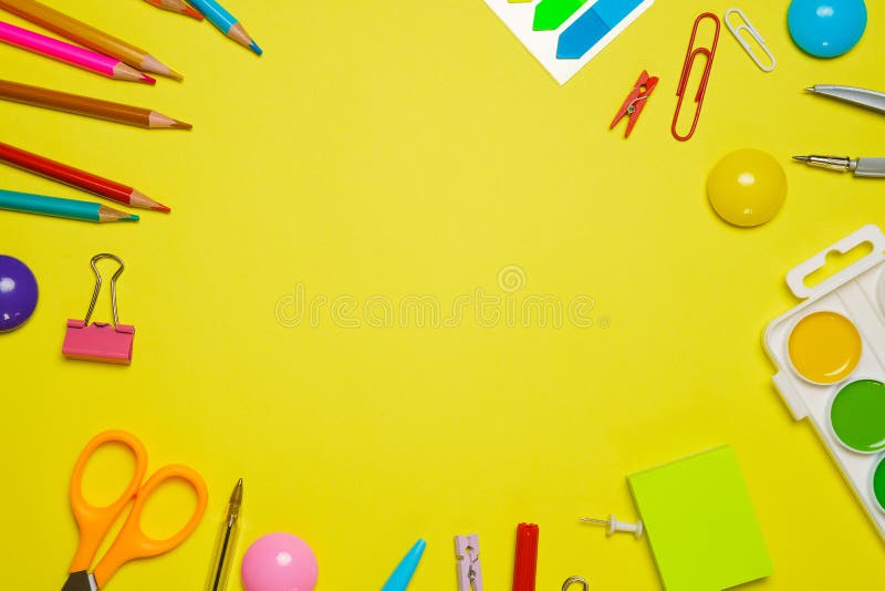 Frame with school supplies on a yellow background. Flat dip, top view. royalty free stock photo
