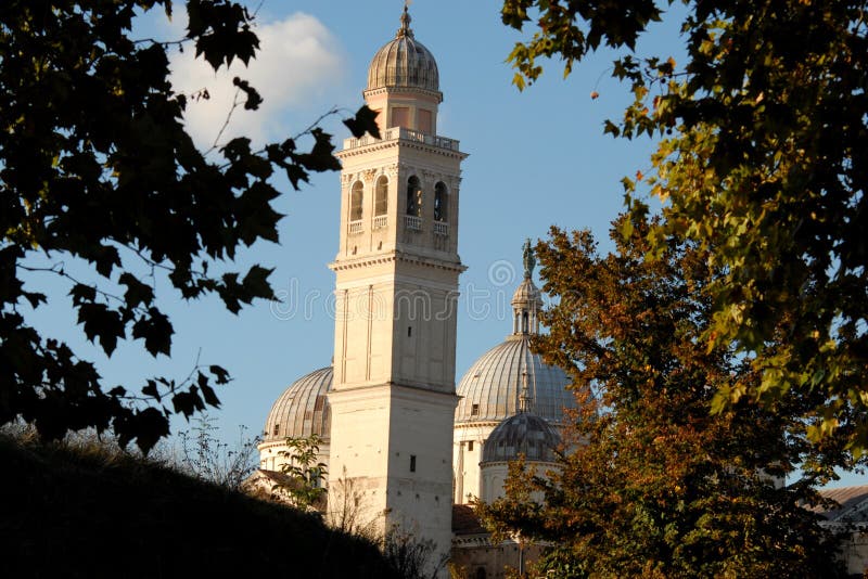 Frame of tree branches to the bell tower and the domes of Santa Giustina in Padua in Veneto (Italy)