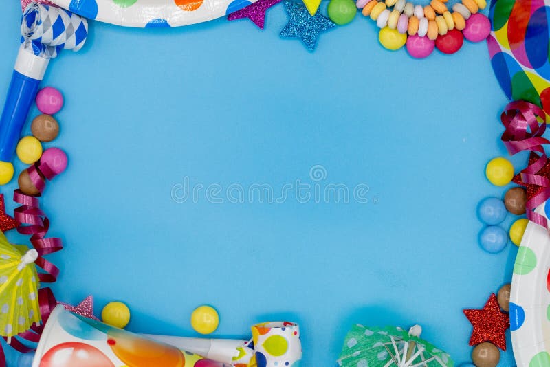 Frame of various sweets and utensils for children\ s birthdays or parties with blue background and copy space